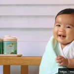아기 생활습관 형성 - A calm and cozy Malaysian nursery scene showing a smiling baby wearing a clean diaper, gently rubbin...